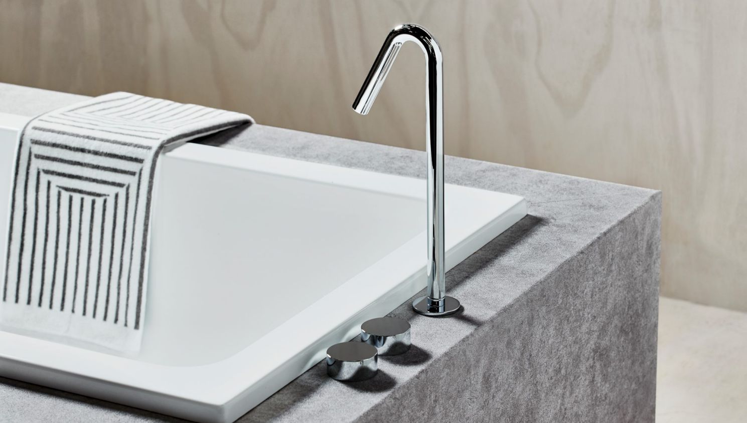 A simple yet elegant sink standing over a modern bath // reece.com.au